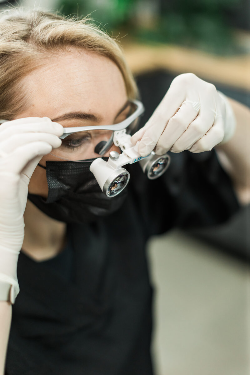 A specialist wearing surgical loupes at the practice.