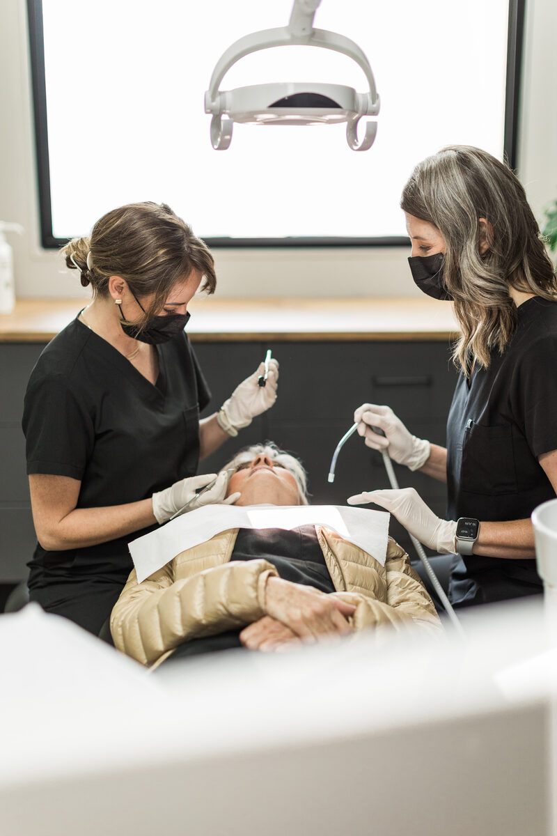 A specialist and assistant during gentle periodontal treatment.